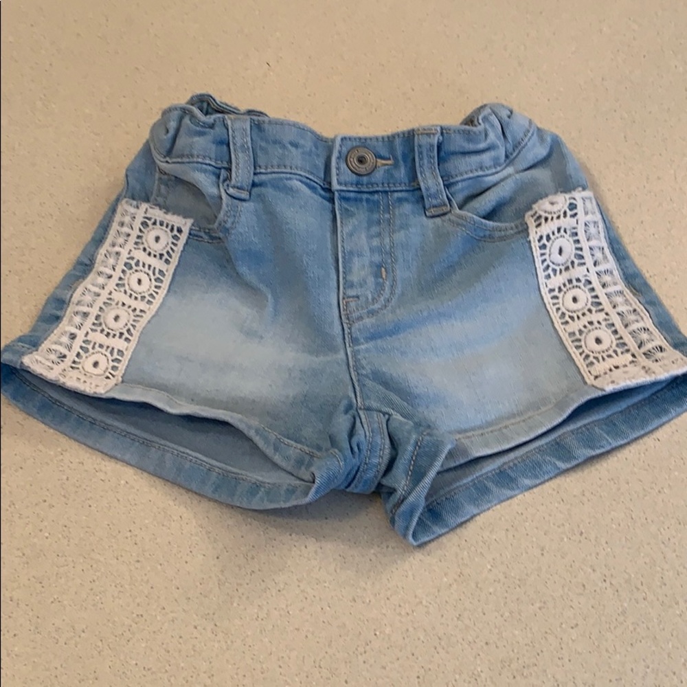 Light blue denim shorts with lace detail